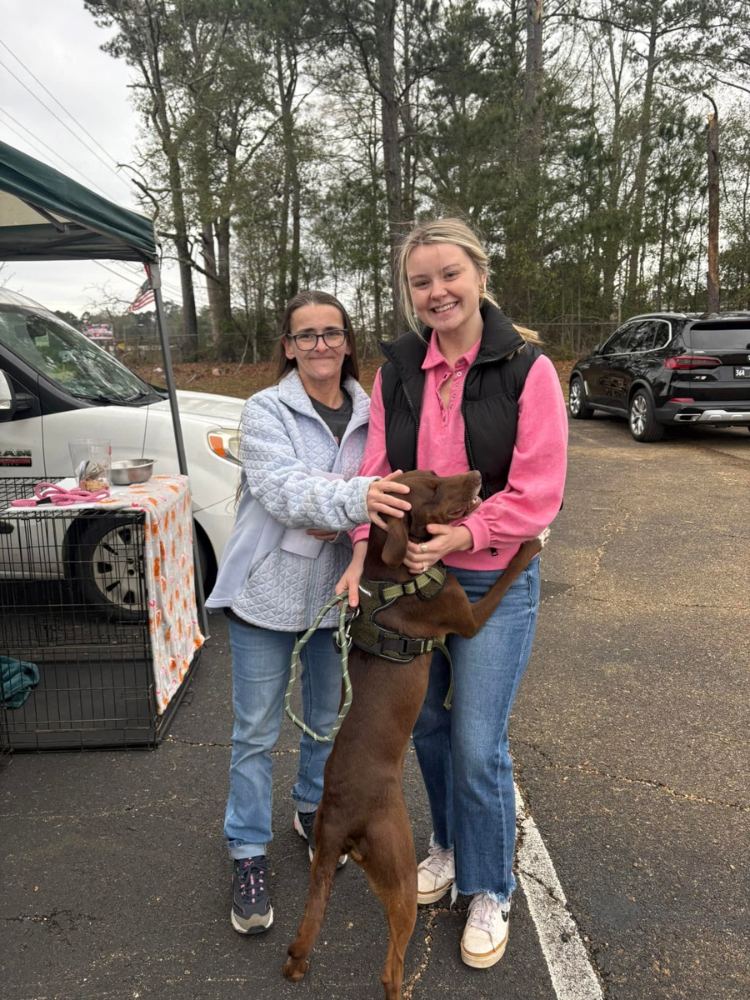 PALS Rescue volunteers with an adopted rescue dog on adoption day in McComb, Mississippi